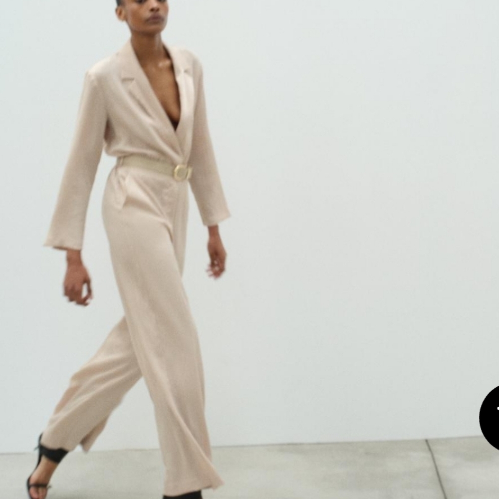 Zara beige wrinkled effect satin jumpsuit with a lapel collar and long sleeves.
